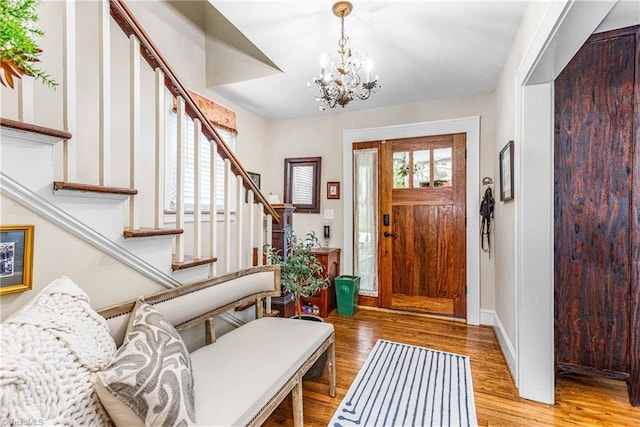 2065 Craig St, Winston-Salem, NC 27103 - foyer with stairs, wood finished floors, and a chandelier