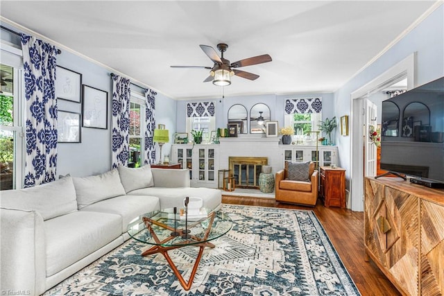 2065 Craig St, Winston-Salem, NC 27103 - living room with wood finished floors, a ceiling fan, ornamental molding, and a brick fireplace
