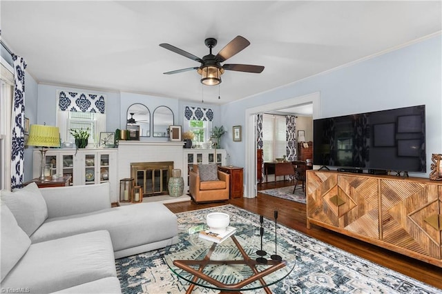 2065 Craig St, Winston-Salem, NC 27103 - living room with wood finished floors, a ceiling fan, crown molding, and a brick fireplace