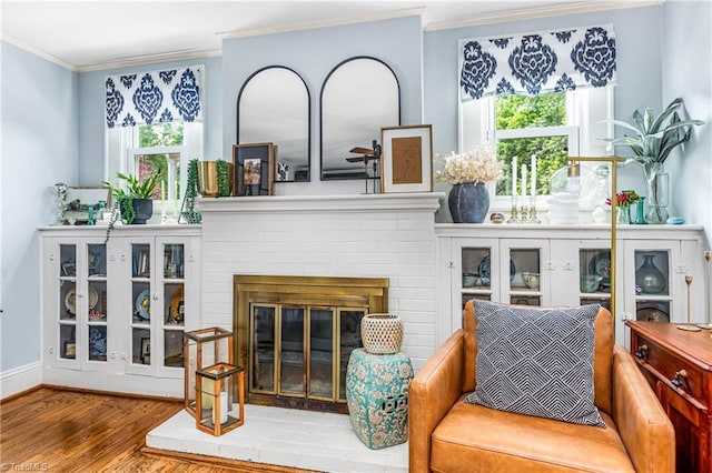 2065 Craig St, Winston-Salem, NC 27103 - living area featuring crown molding, wood finished floors, plenty of natural light, and a brick fireplace