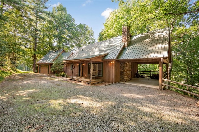 back of house with a carport