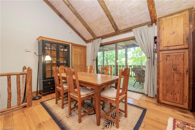 dining space with vaulted ceiling with beams and light hardwood / wood-style flooring