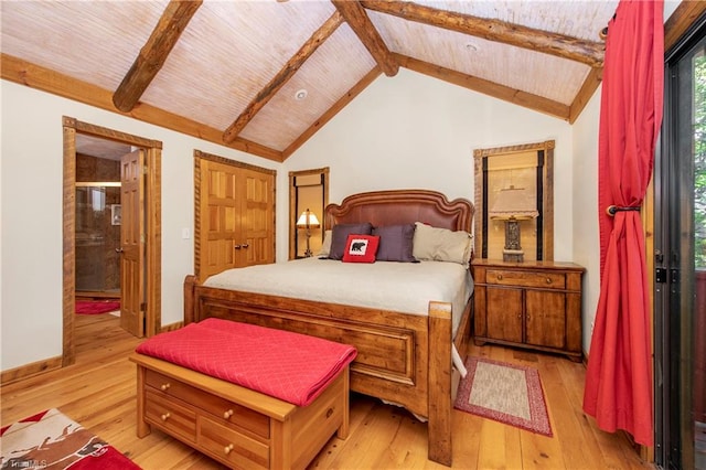 bedroom with lofted ceiling with beams and light hardwood / wood-style flooring