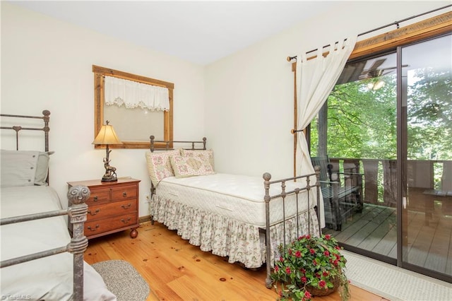 bedroom with wood-type flooring and access to exterior