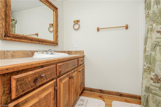 bathroom with vanity and hardwood / wood-style flooring