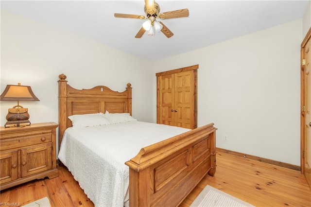 bedroom with light hardwood / wood-style floors and ceiling fan