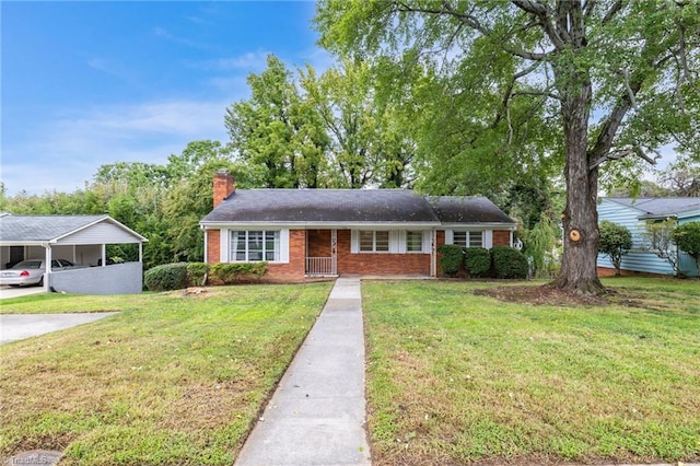 view of front of property with a front yard and a carport