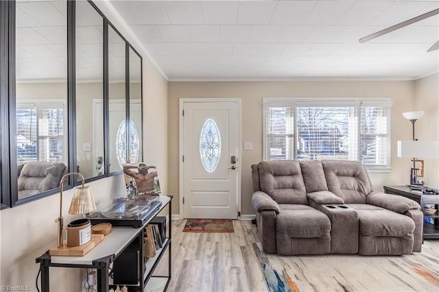 living room with hardwood / wood-style flooring, a healthy amount of sunlight, and ornamental molding