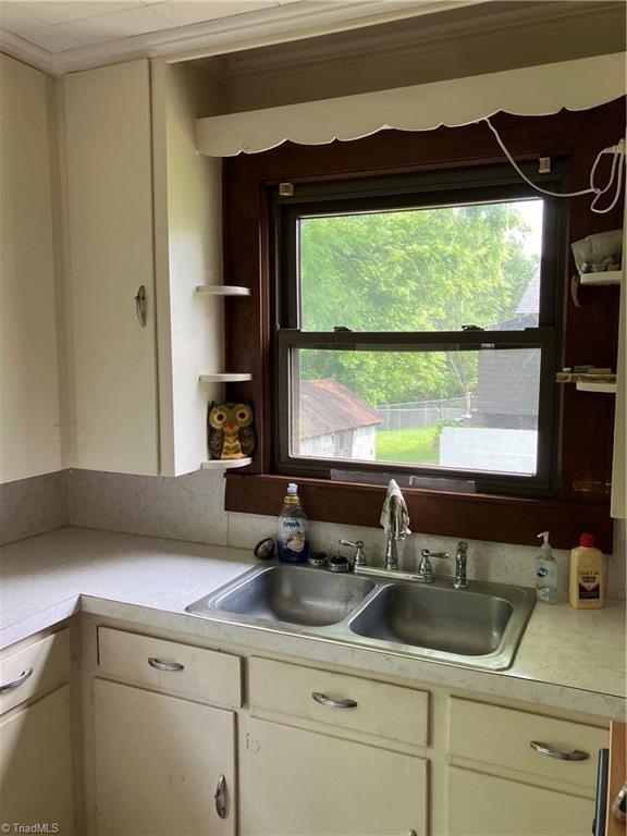 2096 Fancy Gap Rd, Mount Airy, NC 27030 - kitchen featuring light countertops, plenty of natural light, a sink, and white cabinetry