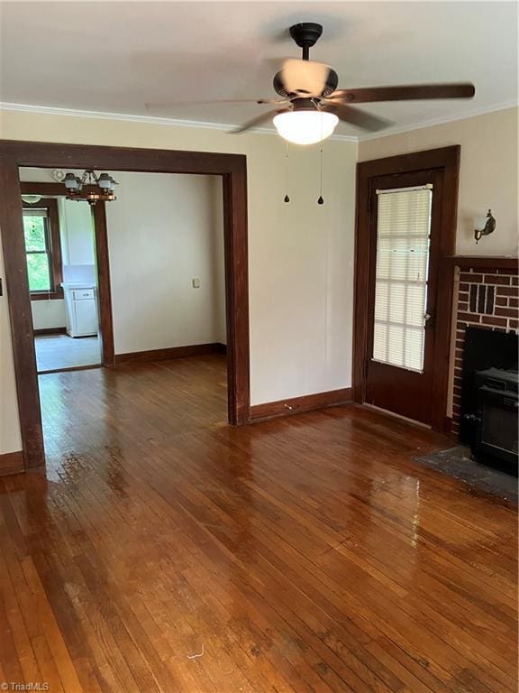 2096 Fancy Gap Rd, Mount Airy, NC 27030 - unfurnished living room with wood-type flooring, baseboards, ornamental molding, a ceiling fan, and a chandelier