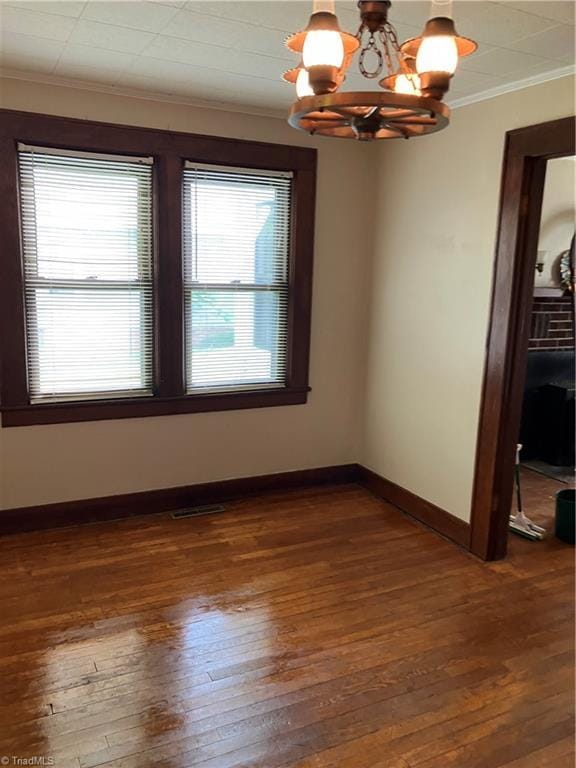 2096 Fancy Gap Rd, Mount Airy, NC 27030 - spare room with crown molding, a chandelier, hardwood / wood-style flooring, and baseboards