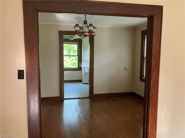 2096 Fancy Gap Rd, Mount Airy, NC 27030 - unfurnished room with crown molding, baseboards, dark wood-style flooring, and a chandelier