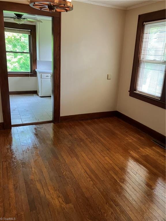 2096 Fancy Gap Rd, Mount Airy, NC 27030 - spare room featuring dark wood-type flooring, ornamental molding, baseboards, and a ceiling fan