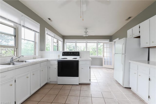 1025 W End Blvd, Winston-Salem, NC 27101 - kitchen with a wealth of natural light, tile counters, electric range oven, and a ceiling fan