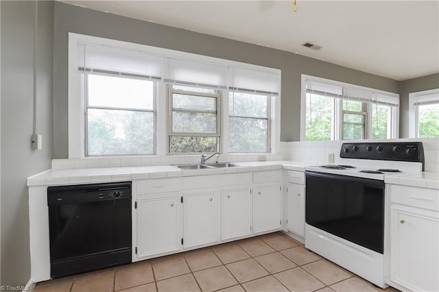 1025 W End Blvd, Winston-Salem, NC 27101 - kitchen with electric stove, a sink, tile counters, white cabinetry, and dishwasher