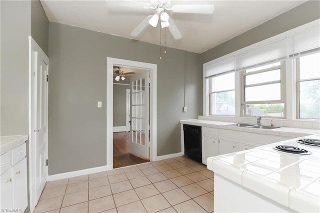 1025 W End Blvd, Winston-Salem, NC 27101 - kitchen with white cabinets, ceiling fan, light tile patterned flooring, dishwasher, and tile countertops