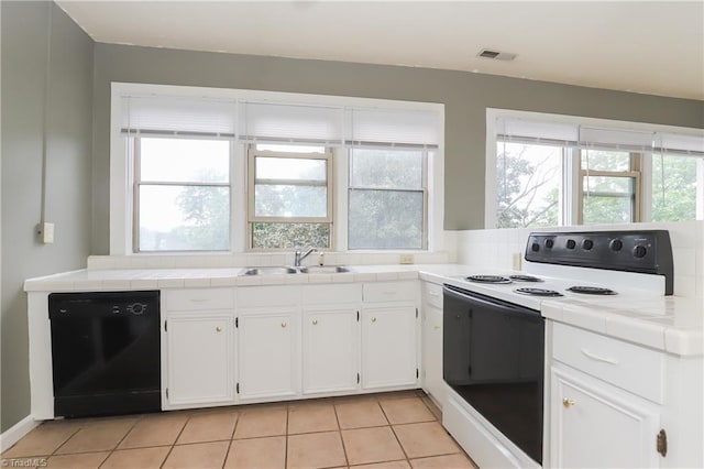 1025 W End Blvd, Winston-Salem, NC 27101 - kitchen featuring range with electric cooktop, tile counters, dishwasher, a sink, and visible vents