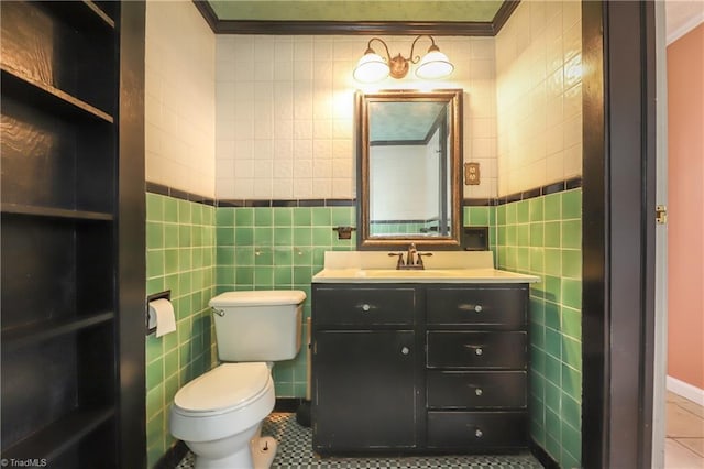 1025 W End Blvd, Winston-Salem, NC 27101 - bathroom with tile patterned floors, tile walls, ornamental molding, toilet, and vanity