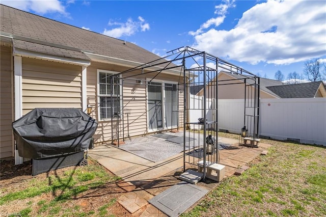 view of patio / terrace with glass enclosure and fence