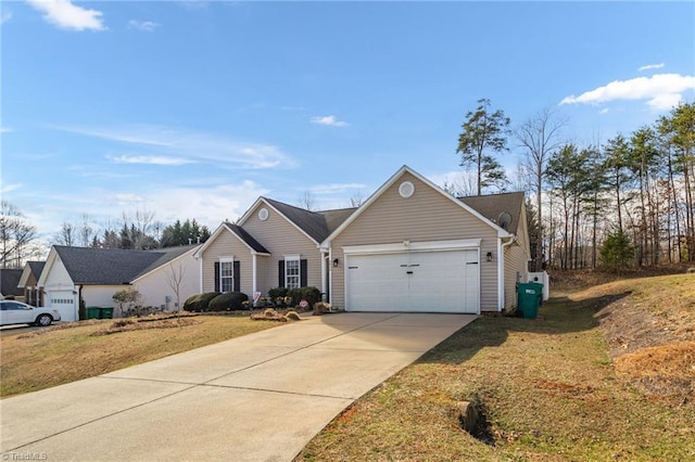 view of front of house featuring a front yard, concrete driveway, and an attached garage