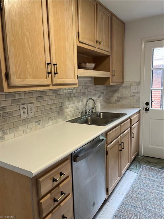 kitchen featuring sink, stainless steel dishwasher, backsplash, and light tile patterned flooring