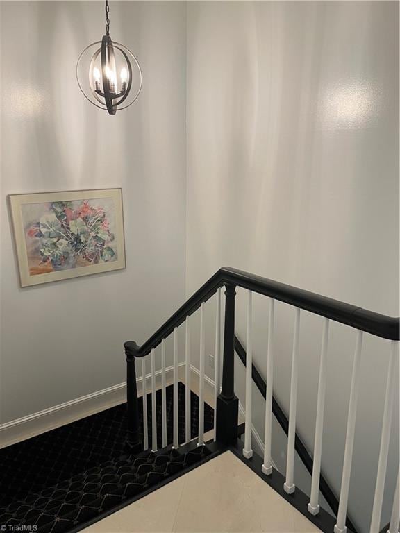 staircase featuring an inviting chandelier and tile patterned floors