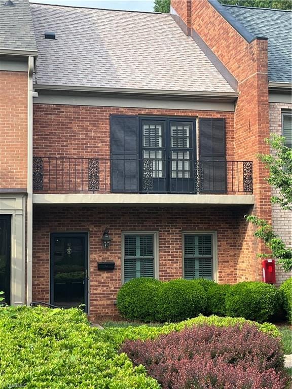 back of property featuring a balcony