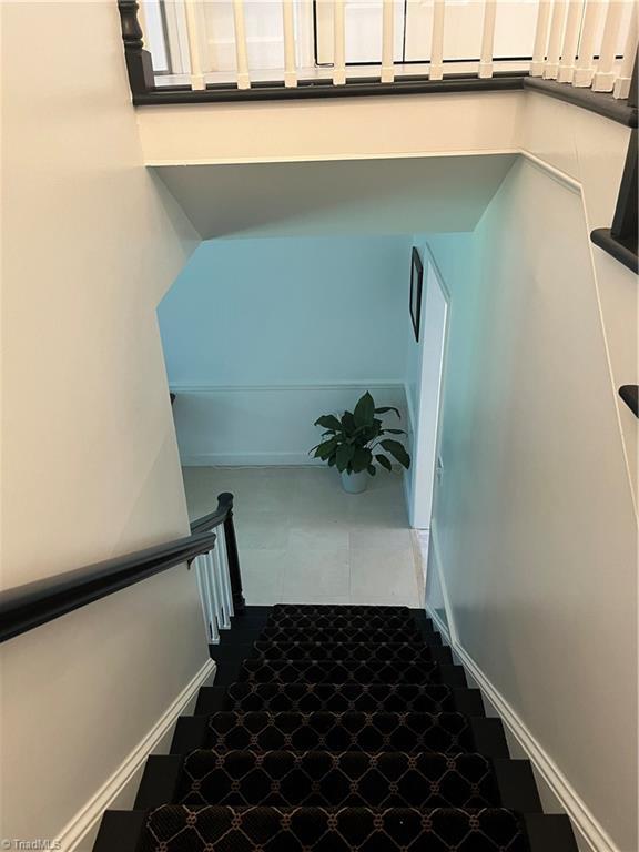 stairway with tile patterned flooring