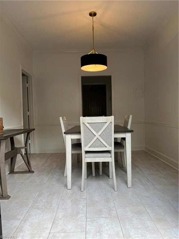 unfurnished dining area featuring crown molding and light tile patterned flooring