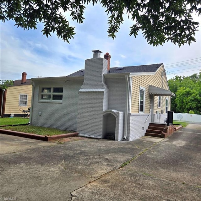 112 Kime St, Burlington, NC 27215 - view of property exterior featuring brick siding and a chimney