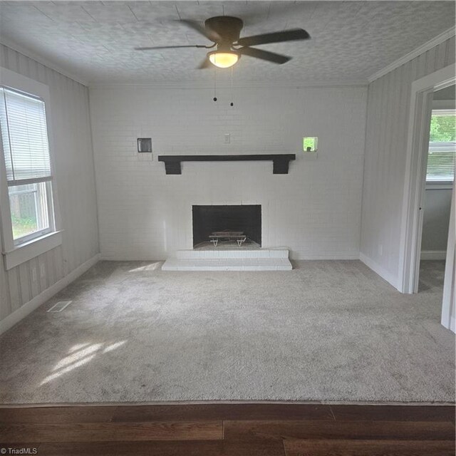 112 Kime St, Burlington, NC 27215 - unfurnished living room featuring ceiling fan, a fireplace, carpet flooring, ornamental molding, and baseboards