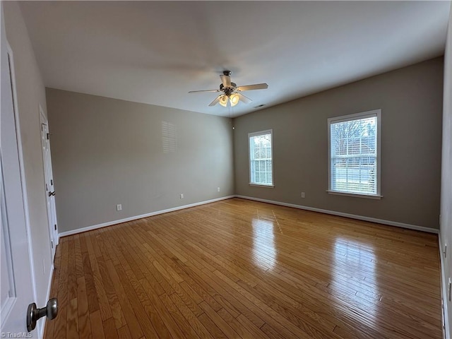 unfurnished room with ceiling fan, light wood-type flooring, and baseboards