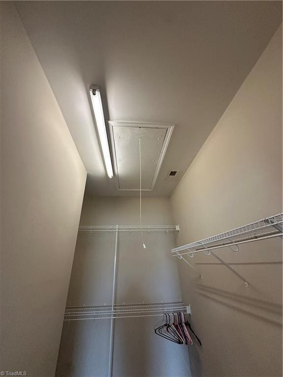 walk in closet with attic access and visible vents