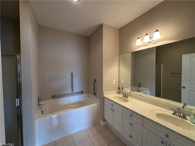 bathroom with tile patterned flooring, a garden tub, a sink, and double vanity