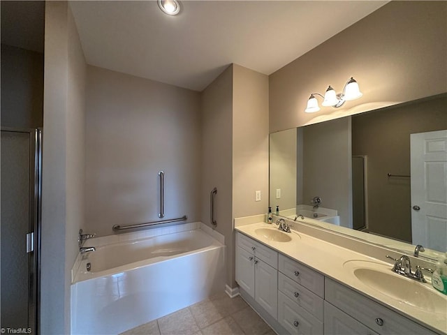 full bathroom featuring tile patterned flooring, double vanity, a sink, and a bath