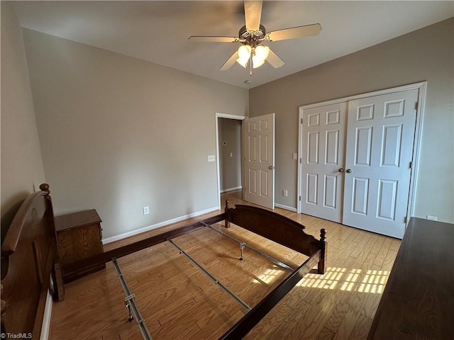 unfurnished bedroom featuring light wood finished floors, ceiling fan, and baseboards