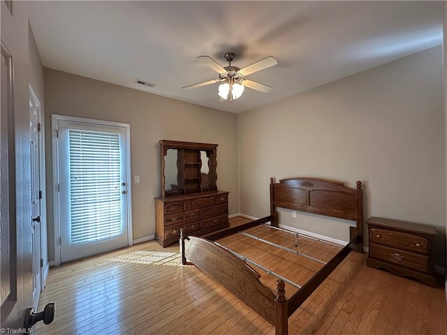 bedroom featuring visible vents, light wood-style flooring, a ceiling fan, access to outside, and baseboards