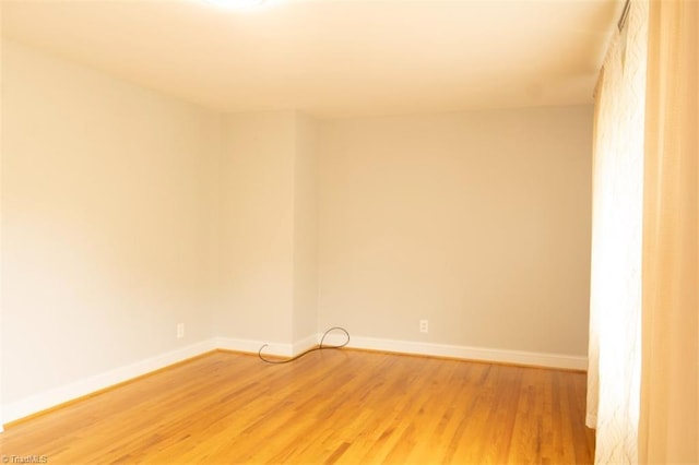 spare room featuring wood-type flooring