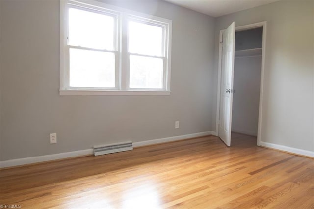 unfurnished bedroom featuring a closet and light hardwood / wood-style floors