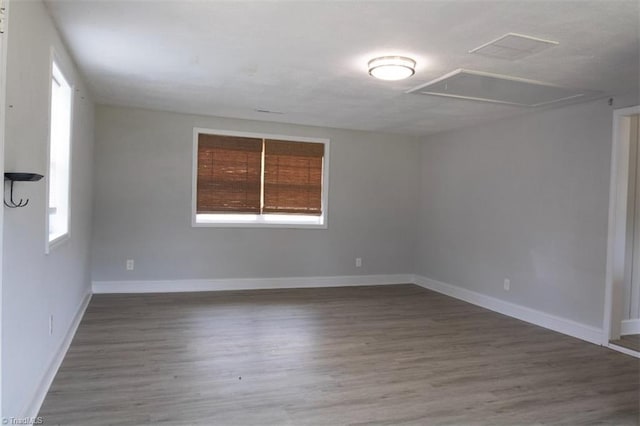 empty room featuring plenty of natural light and wood-type flooring