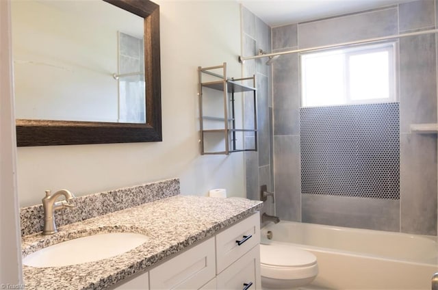 full bathroom with vanity, toilet, and tiled shower / bath