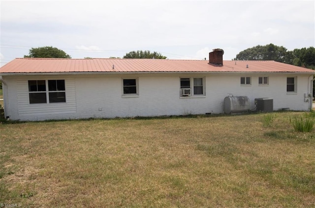 back of property featuring a yard and cooling unit