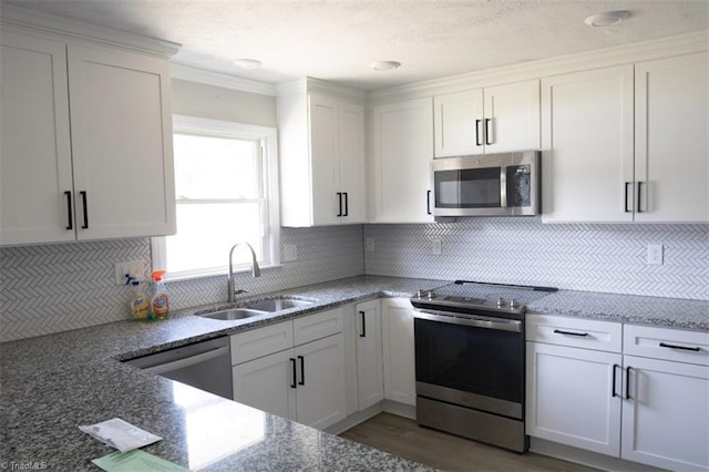 kitchen featuring sink, white cabinetry, and appliances with stainless steel finishes