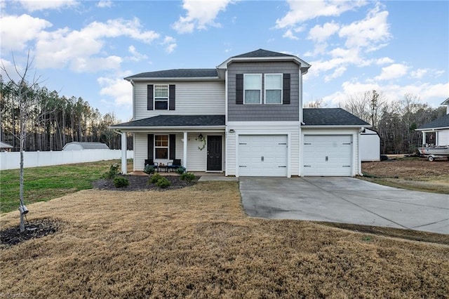 view of property with a porch, a garage, and a front lawn