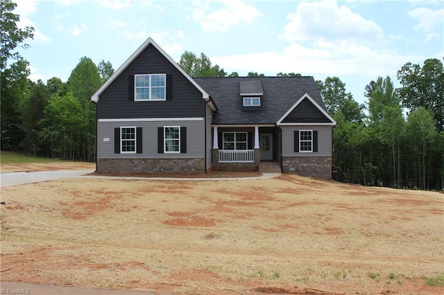 craftsman inspired home with covered porch and brick siding