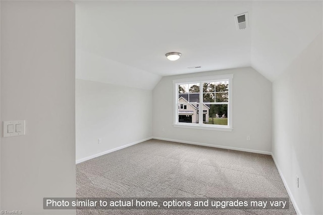 additional living space featuring lofted ceiling, carpet floors, and baseboards