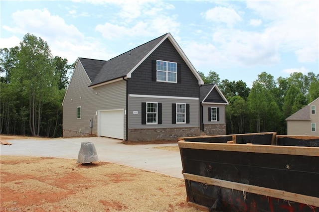 view of property exterior featuring driveway and an attached garage