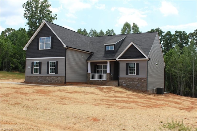 craftsman-style home featuring a porch, brick siding, and central AC