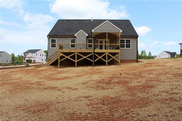 rear view of house featuring a wooden deck, crawl space, and roof with shingles