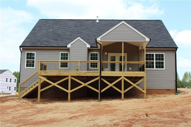 rear view of property featuring a deck, crawl space, and a shingled roof